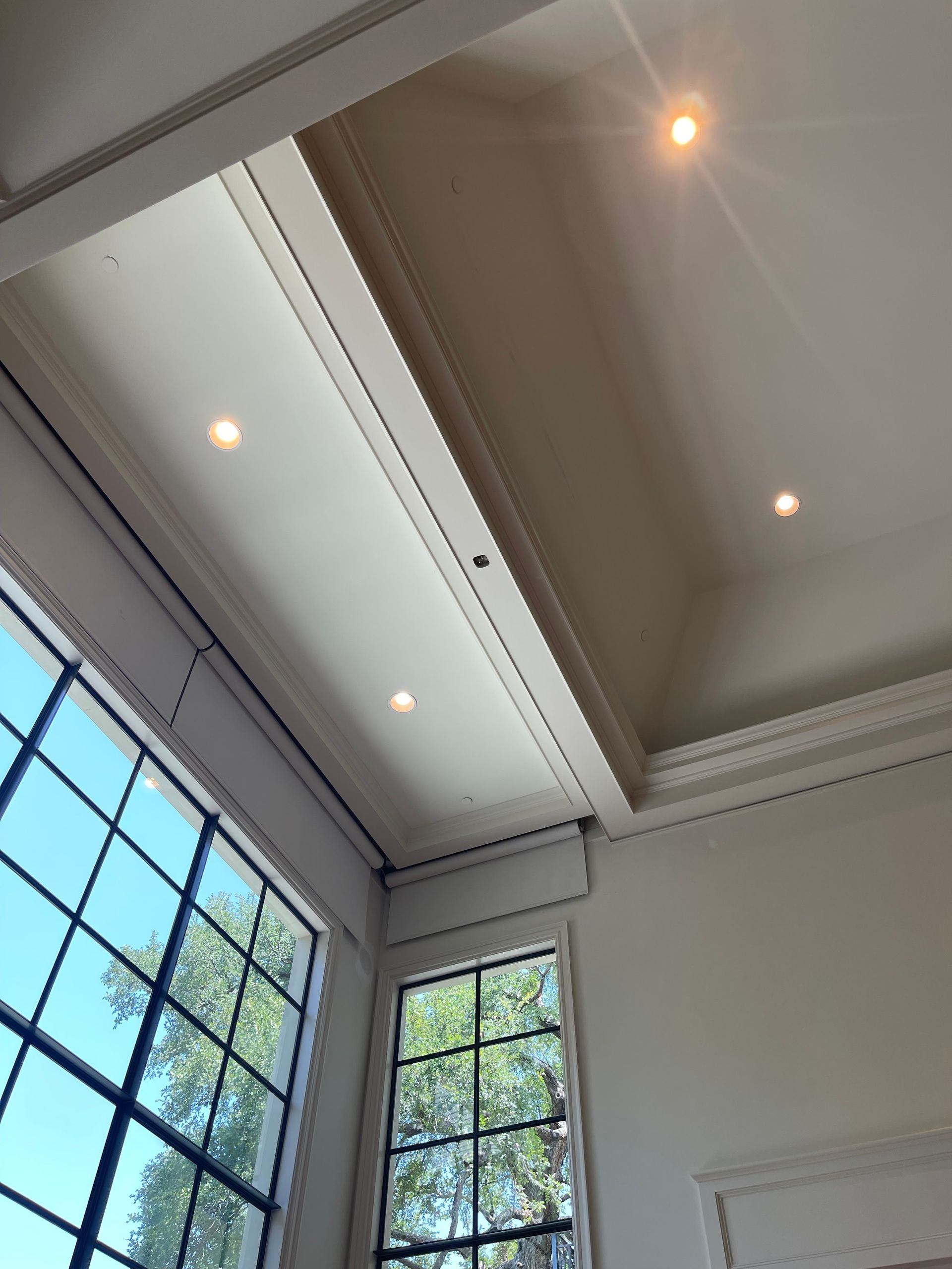 A large house with a lot of windows and a garage on a rainy day.