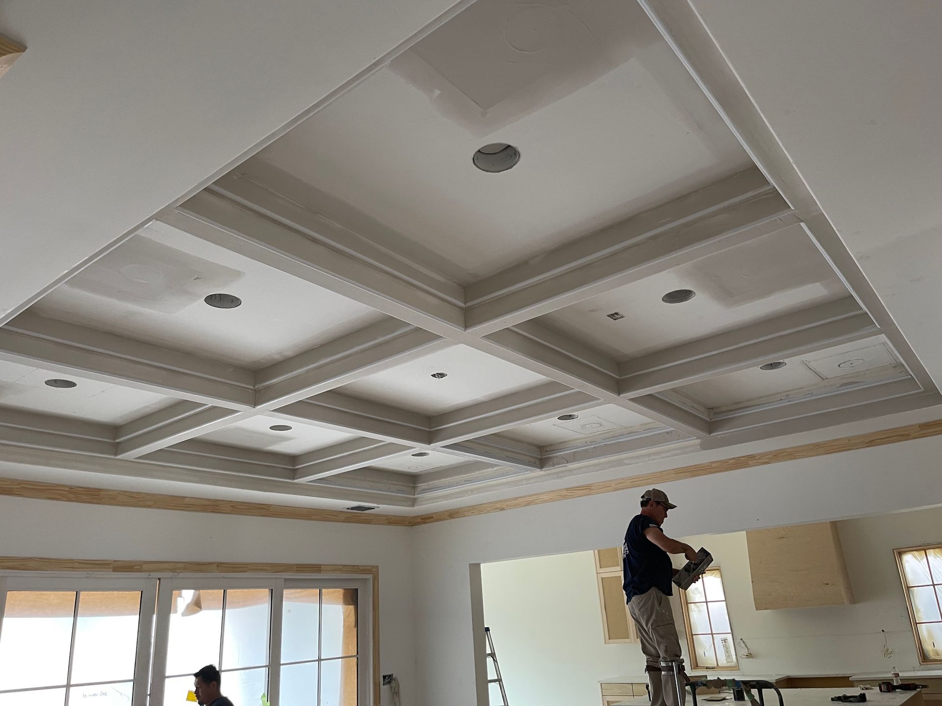 A large house with a lot of windows and a garage on a rainy day.