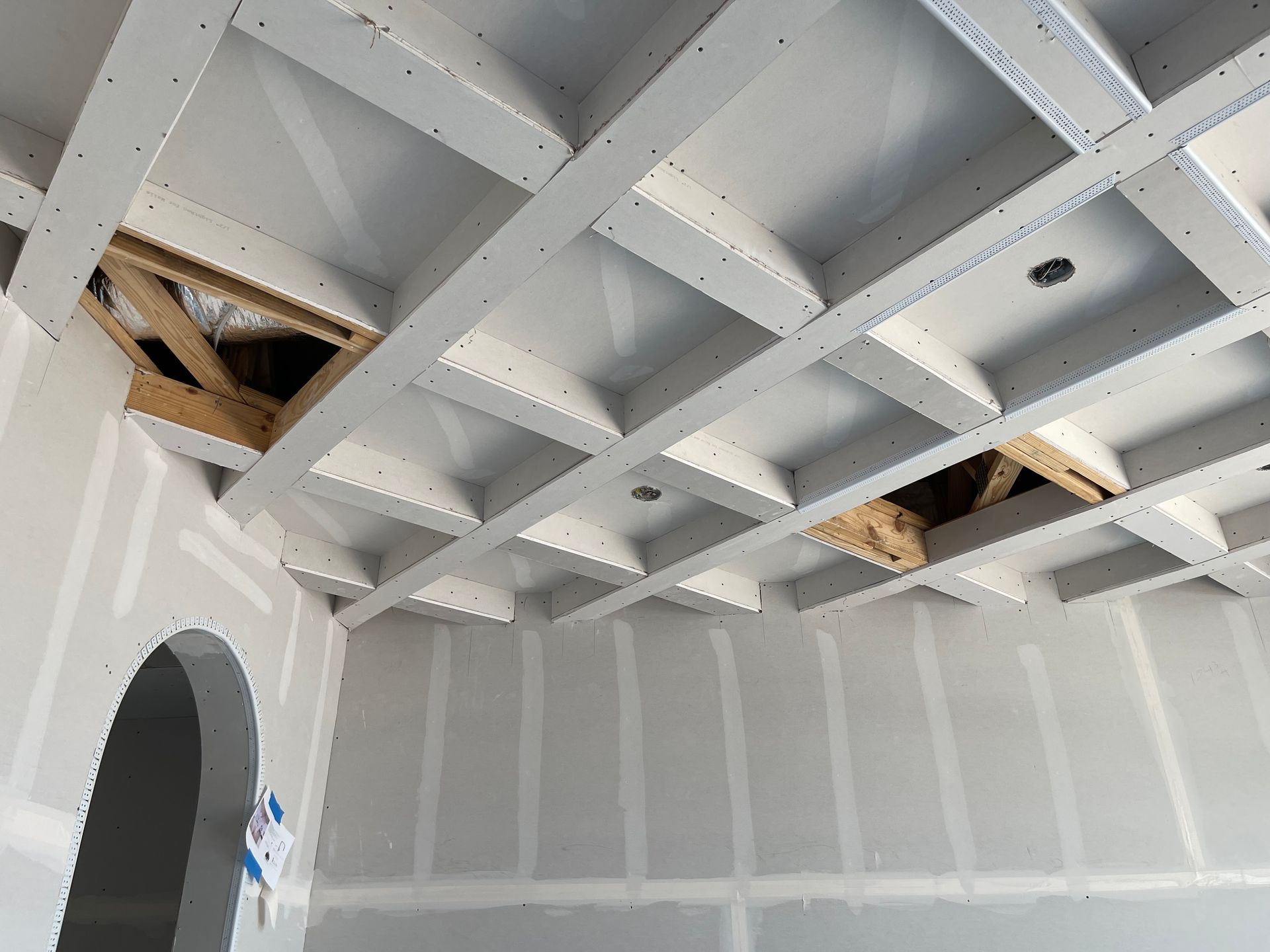 A large house with a lot of windows and a garage on a rainy day.
