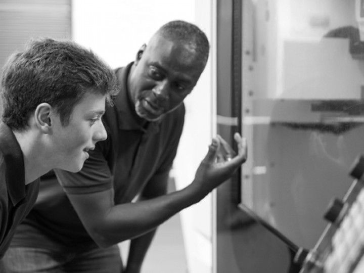 Black man talking to a boy