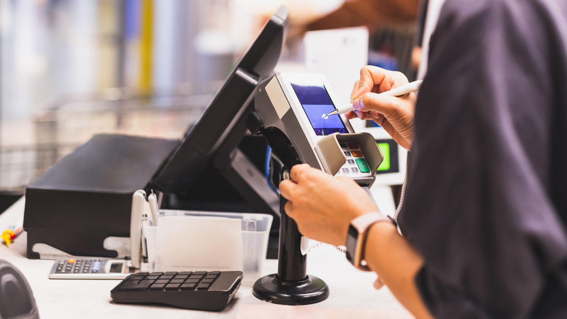 A person is using a credit card at a cash register.