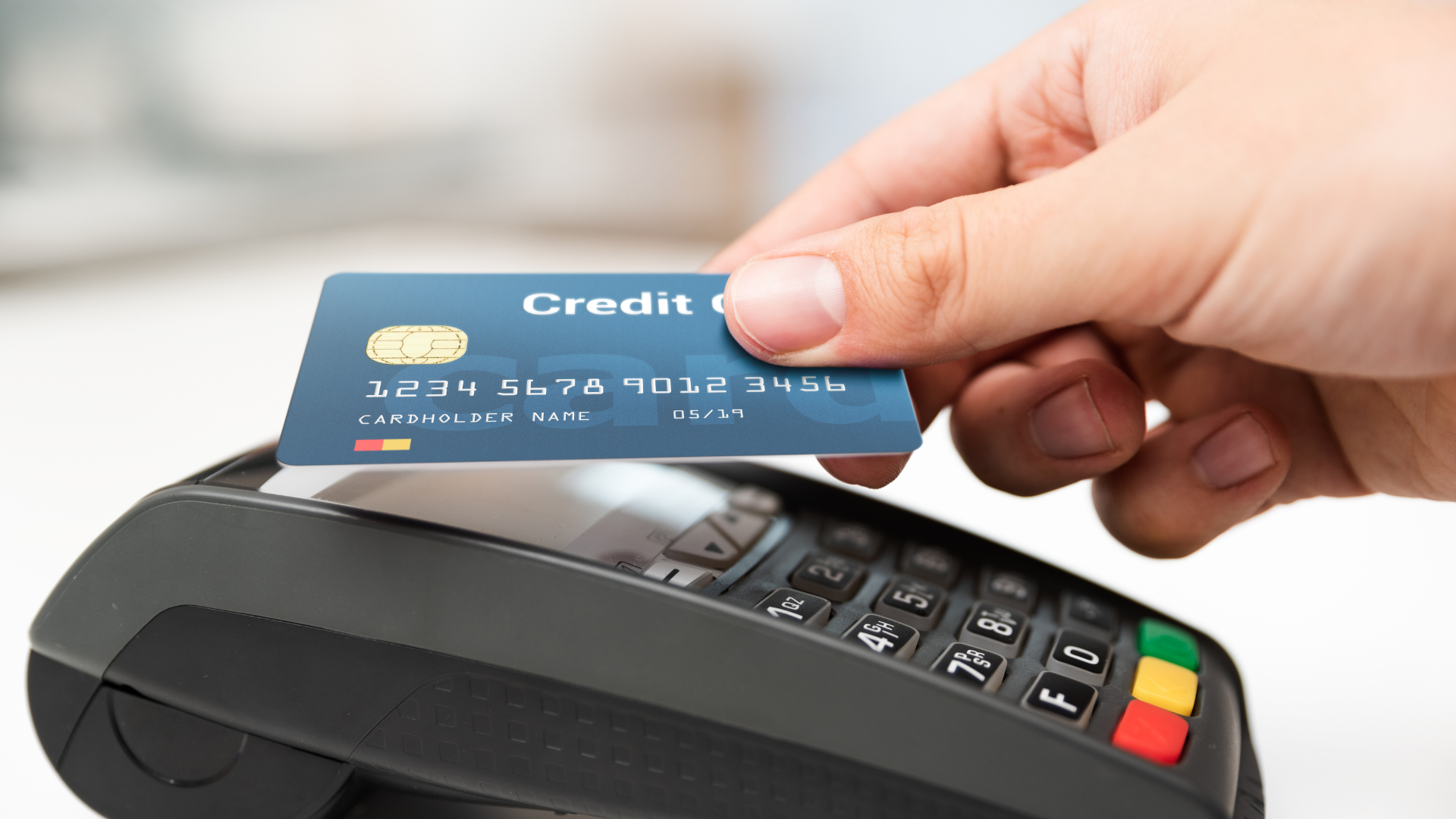 A person is using a credit card to pay for something.