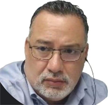 A man with glasses and a beard is wearing a headset.