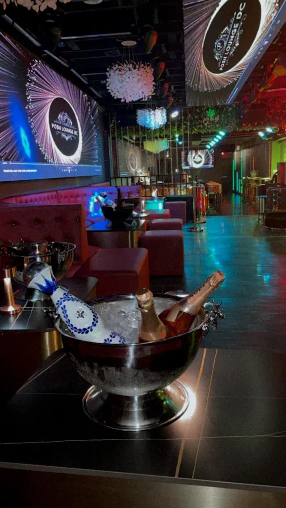 A bucket of champagne is sitting on a table in a restaurant.