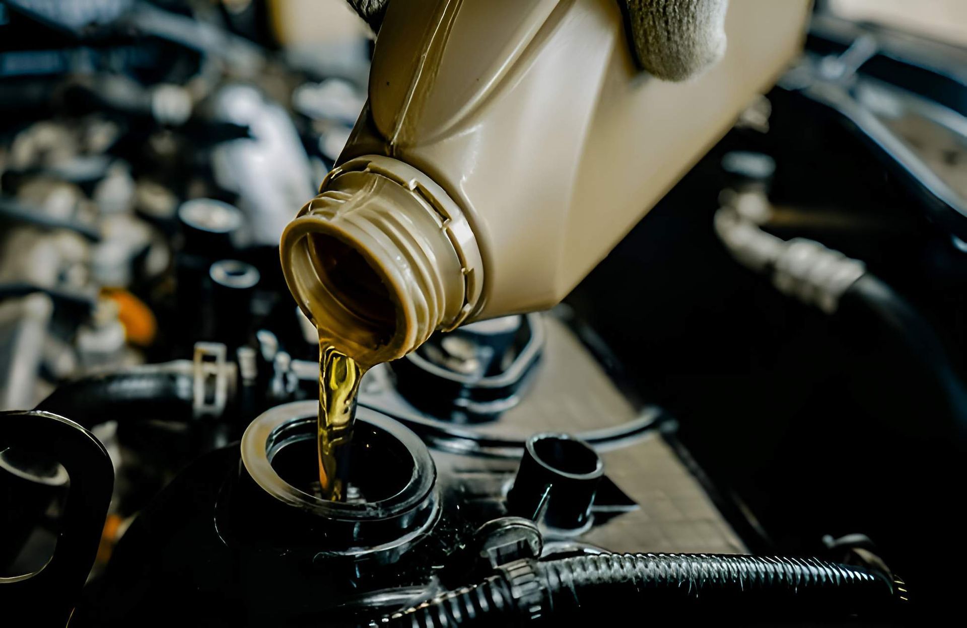 A Person is Pouring Oil Into a Car Engine — Mid Coast Bearing Centre in Bulahdelah, NSW