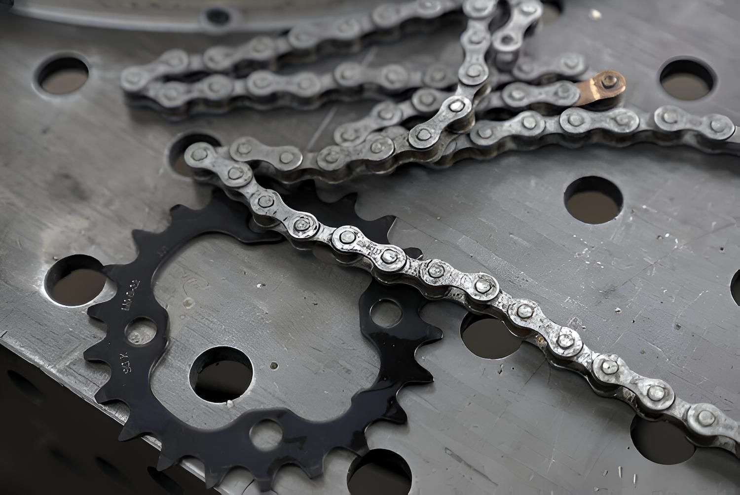 A Close Up of a Chain and a Gear on a Metal Surface — Mid Coast Bearing Centre in Gloucester, NSW
