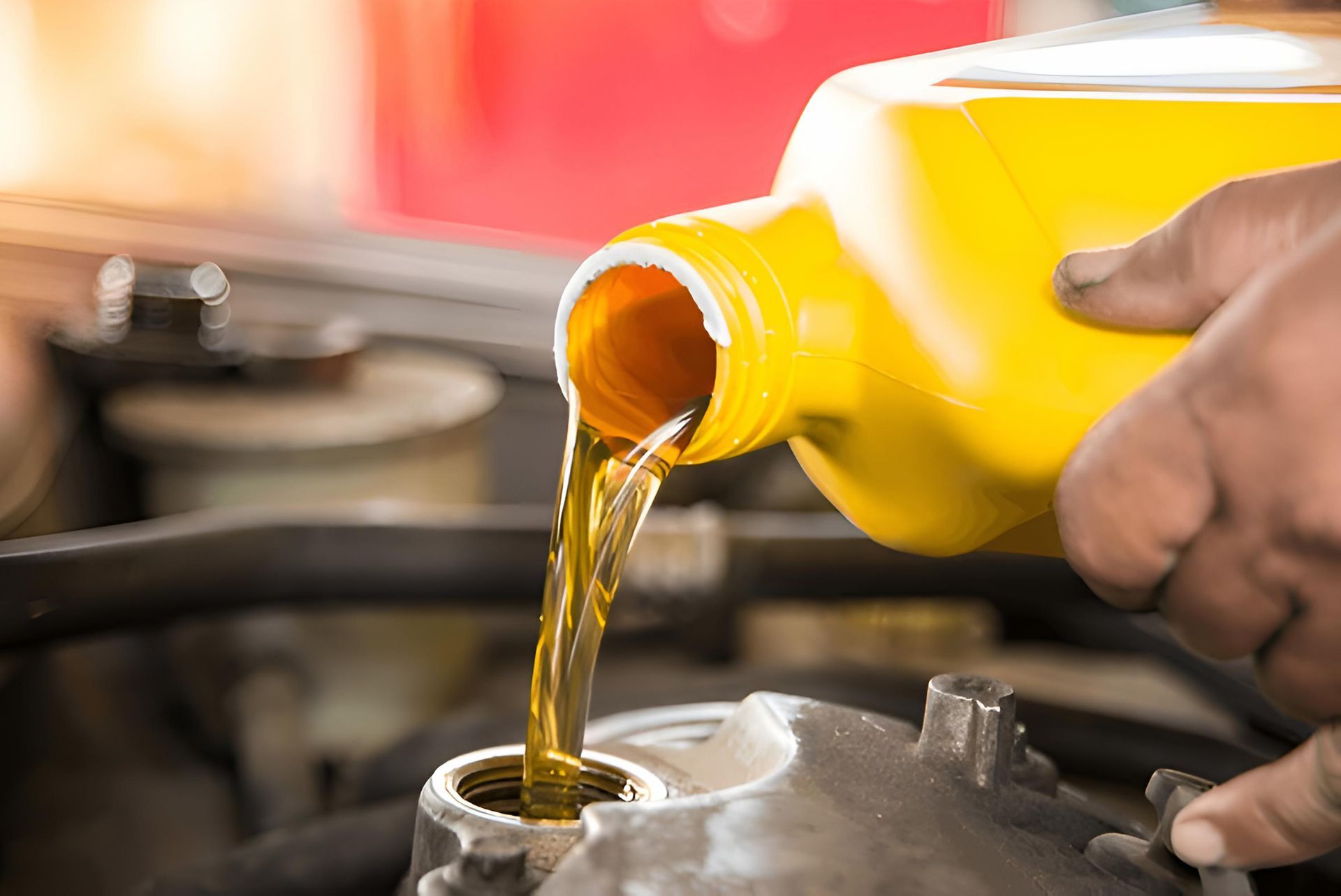A Person is Pouring Oil Into a Car Engine — Mid Coast Bearing Centre in Forster, NSW