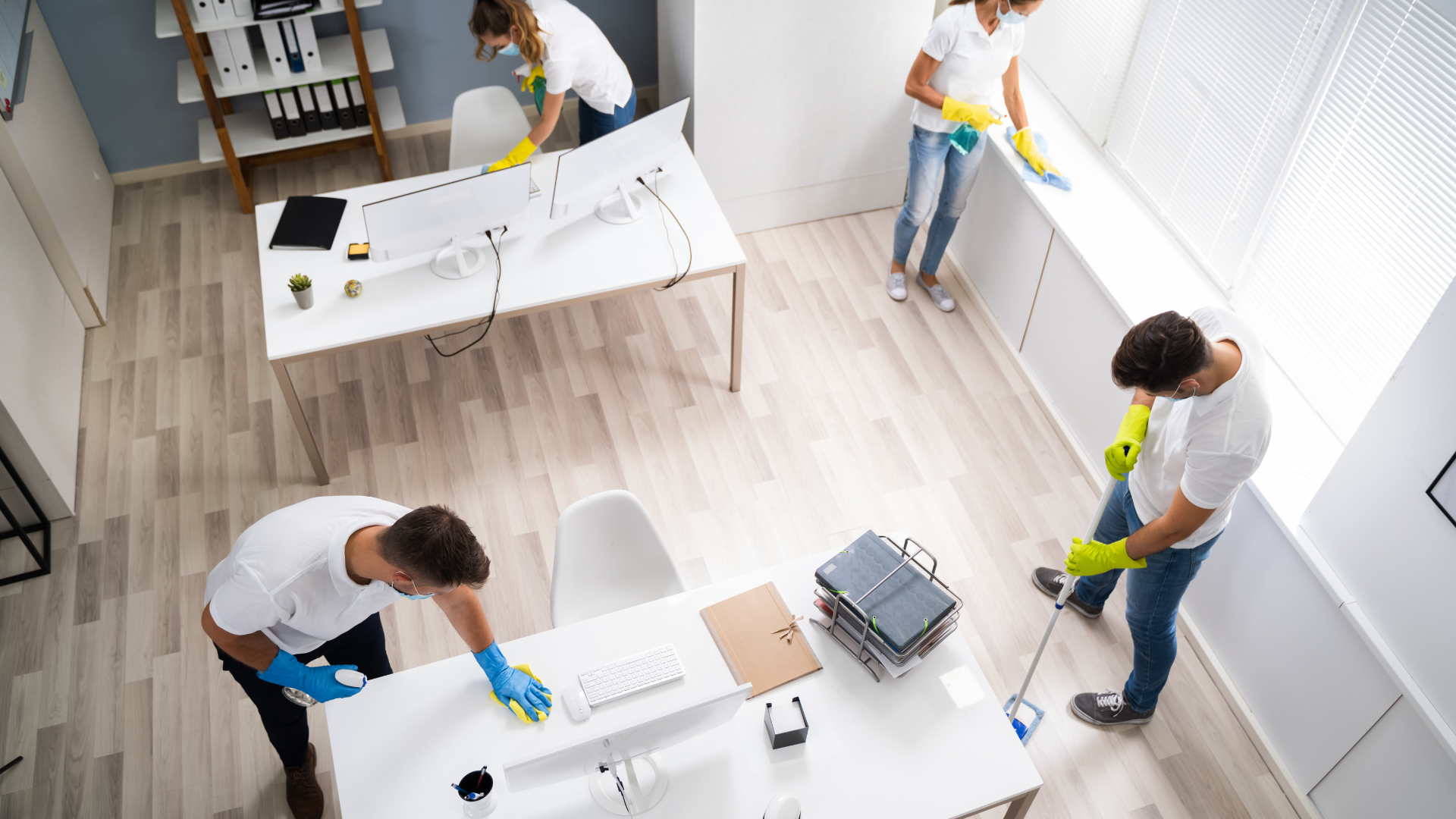 A group of people are cleaning an office.