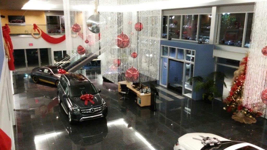 An aerial view of a car dealership decorated for christmas