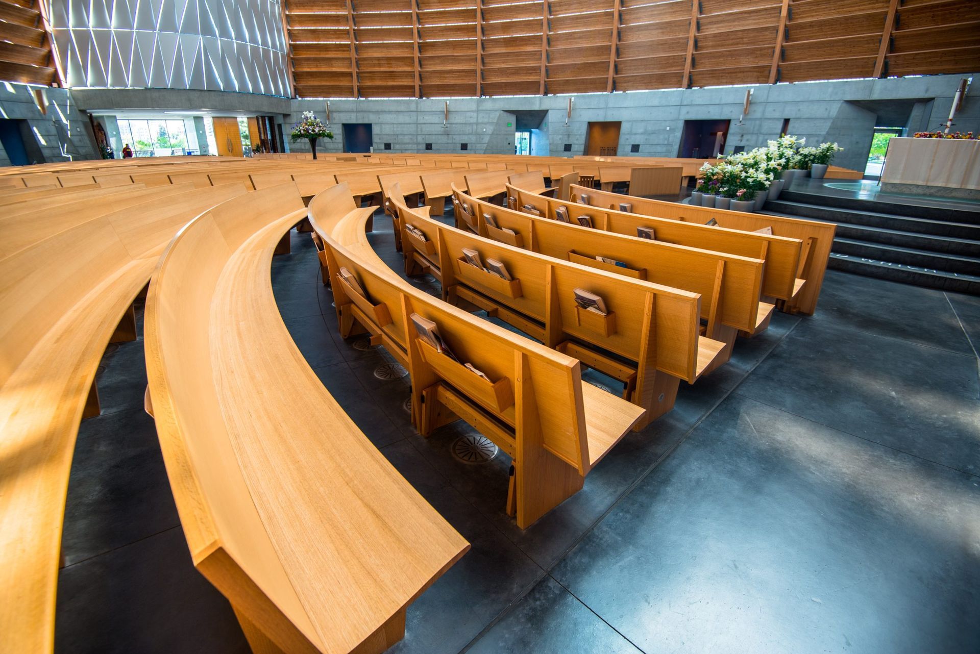 Rows of wooden benches are lined up in a church