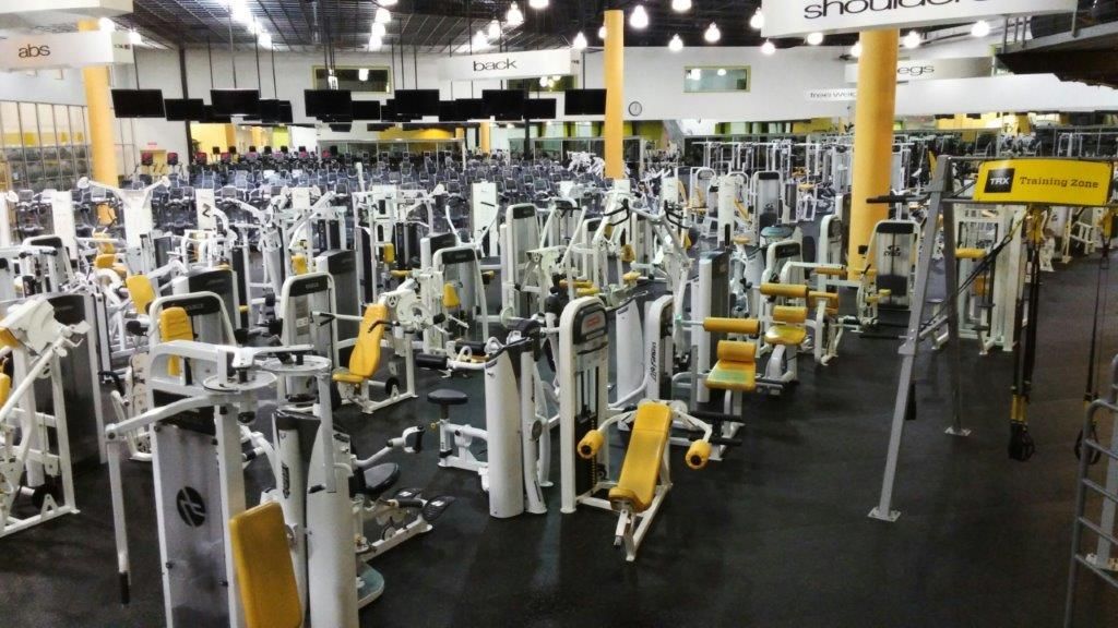 A large gym filled with lots of exercise equipment