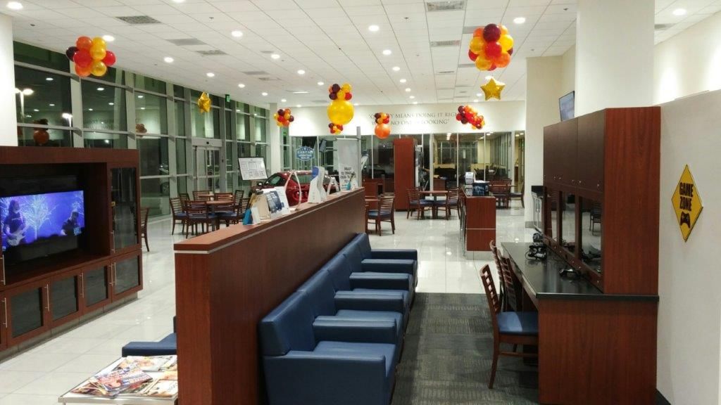 A large room with balloons hanging from the ceiling