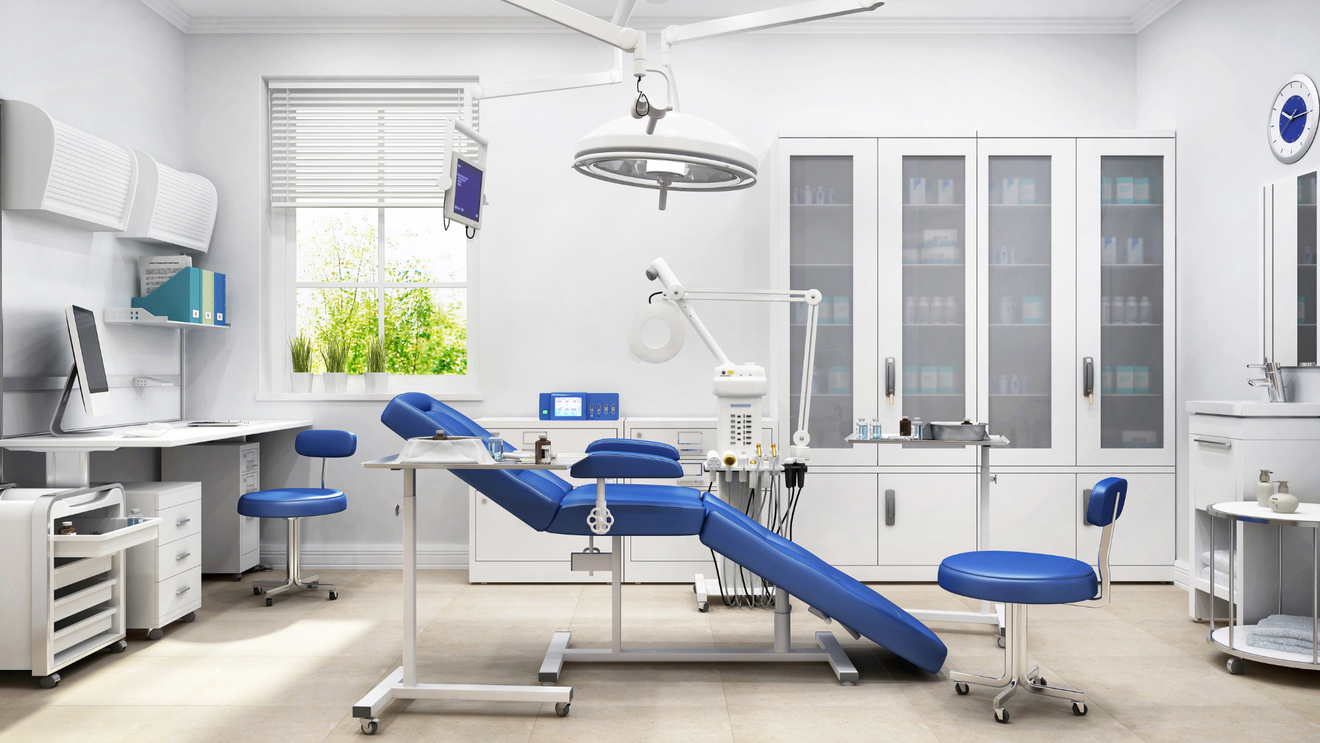 A dental office with a blue dental chair and a computer.