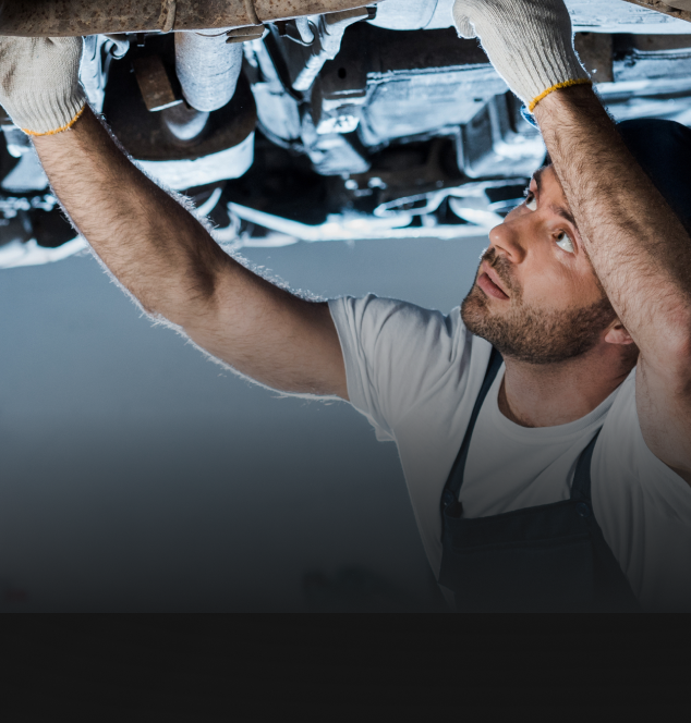 mechanic working under car | Noller Fleet & Auto Service