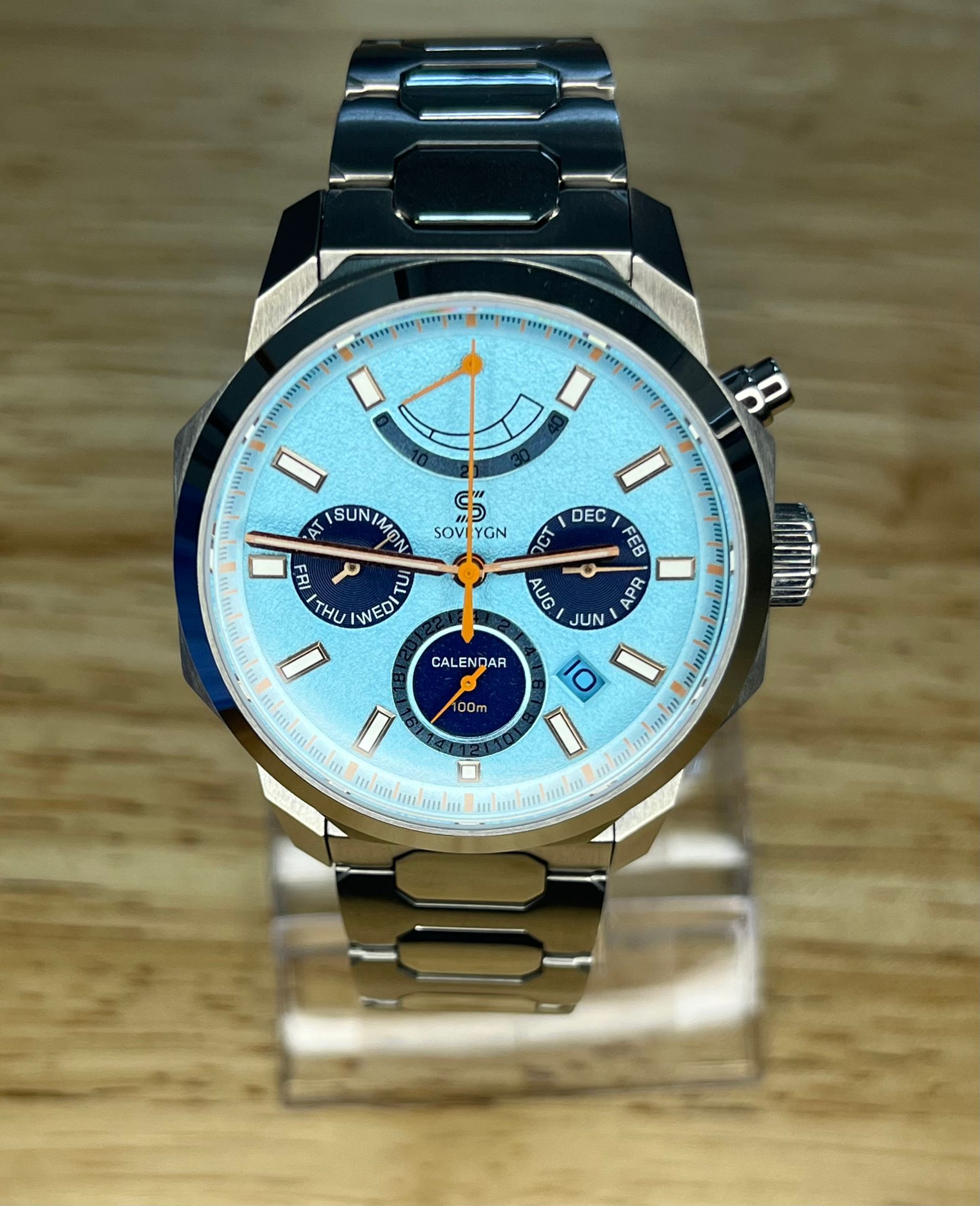 Silver wristwatch with a light blue face and stainless steel band.