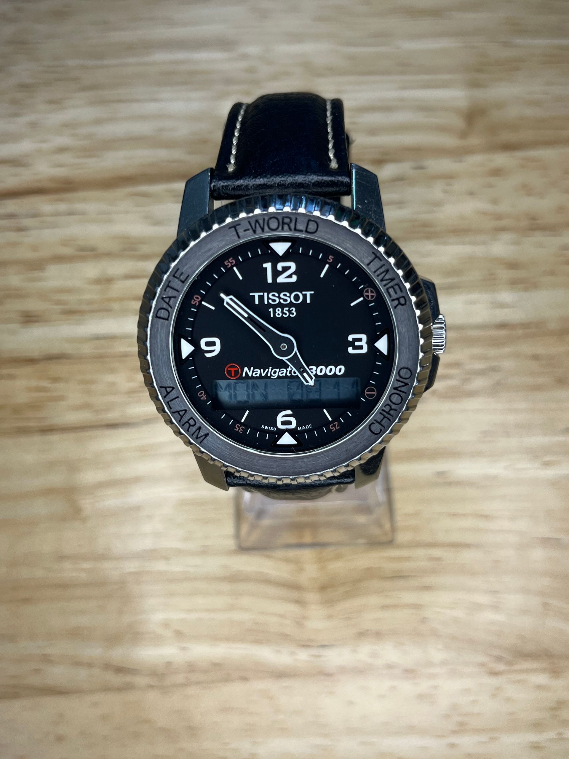 Tissot T-Touch watch with a black dial, black leather strap, and digital display.
