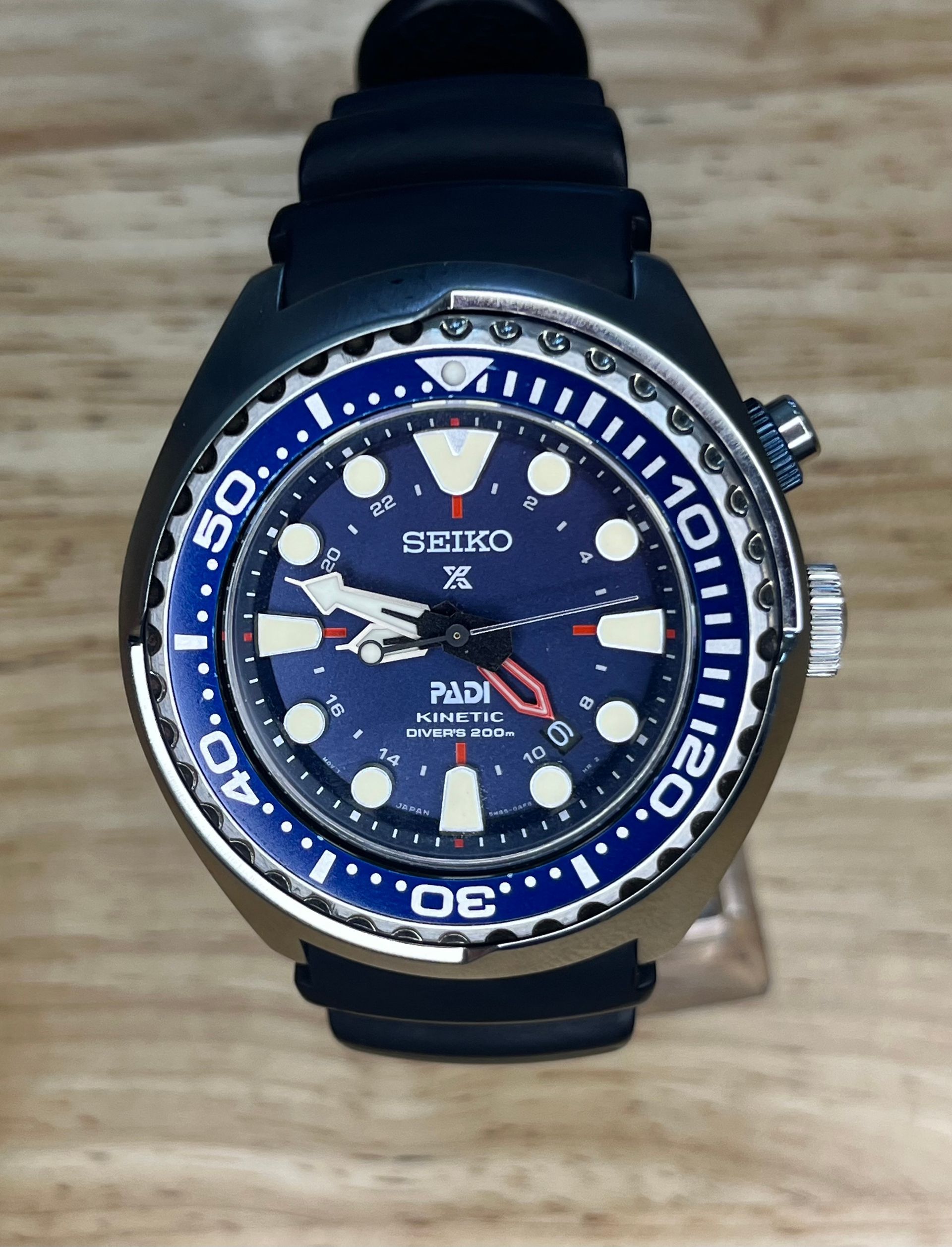 Seiko "PADI" dive watch with blue face and bezel on a black rubber strap.