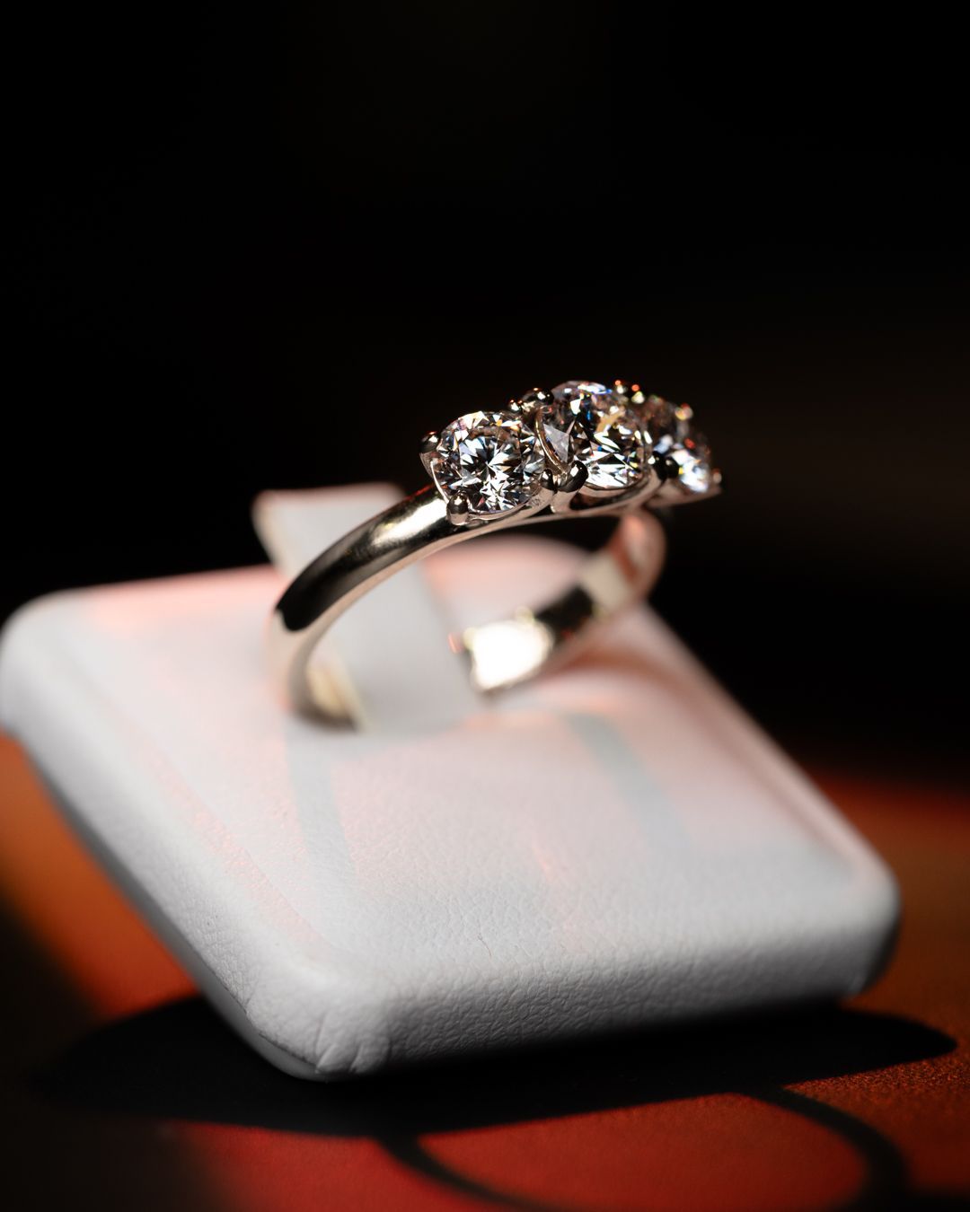 Un anello di diamanti è appoggiato su un cuscino bianco