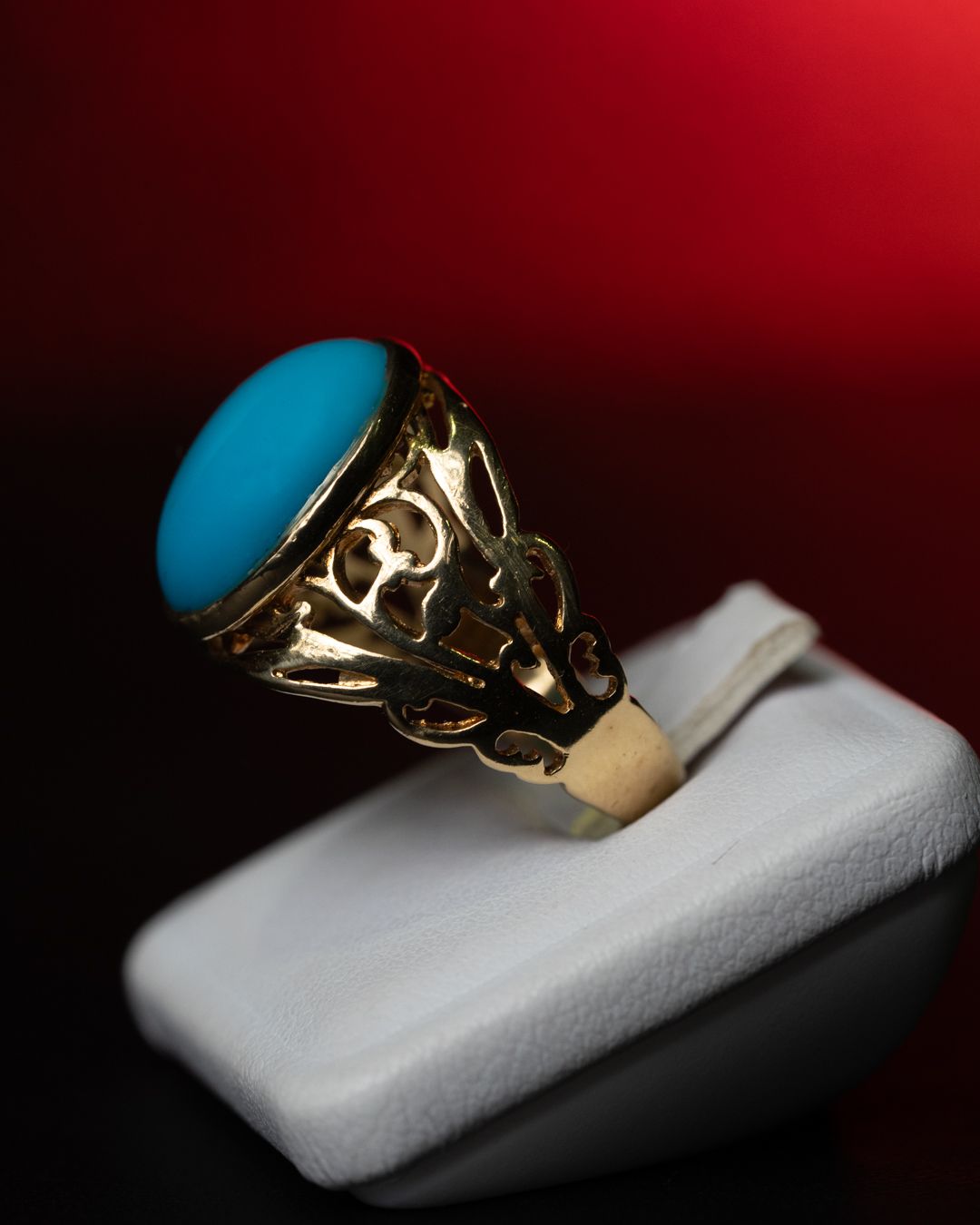 Un anello d'oro con una pietra turchese al centro