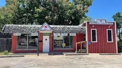 Burleson Electrician - A Old fashioned red and white BBQ restaurant with rustic shingles, an open sign, and surrounding trees on a sunny day. Cozy, inviting atmosphere.