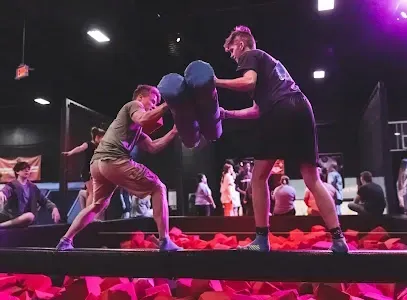 Burleson Electrician - A tranquil sunset over a lake with vibrant pink and orange clouds reflecting on the water. Silhouetted trees create a serene, peaceful atmosphere.