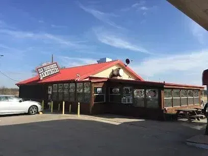 Burleson Electrician
- Rural BBQ restaurant with a red roof, large sign, and reflective windows. A white car is parked outside, under a clear blue sky. Rustic atmosphere.