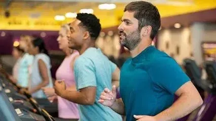 Burleson Electrician - People are jogging on treadmills in a gym, focused and energized. The room is well-lit with a yellow ceiling, creating an active, motivational atmosphere.