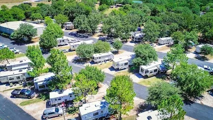 Burleson Electrician -Entrance archway to Chisenhall Fields with text on top, surrounded by manicured lawns and a bright blue sky with clouds.