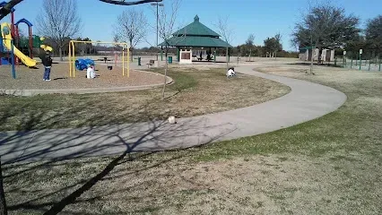 Burleson Electrician - A tranquil sunset over a lake with vibrant pink and orange clouds reflecting on the water. Silhouetted trees create a serene, peaceful atmosphere.