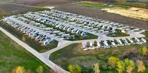 Burleson Electrician - Aerial view of a large RV park filled with numerous recreational vehicles parked in organized rows on gravel and grass.