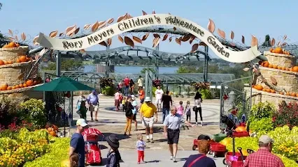 Burleson Electrician 
- Playground scene with children on a blue slide and swings. A colorful climbing structure sits nearby. 