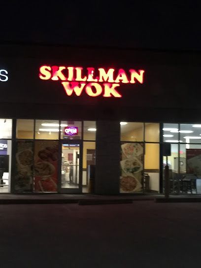 Burleson Electrician -A round black picnic table with attached seats is set on lush green grass, surrounded by leafless trees under a clear blue sky.