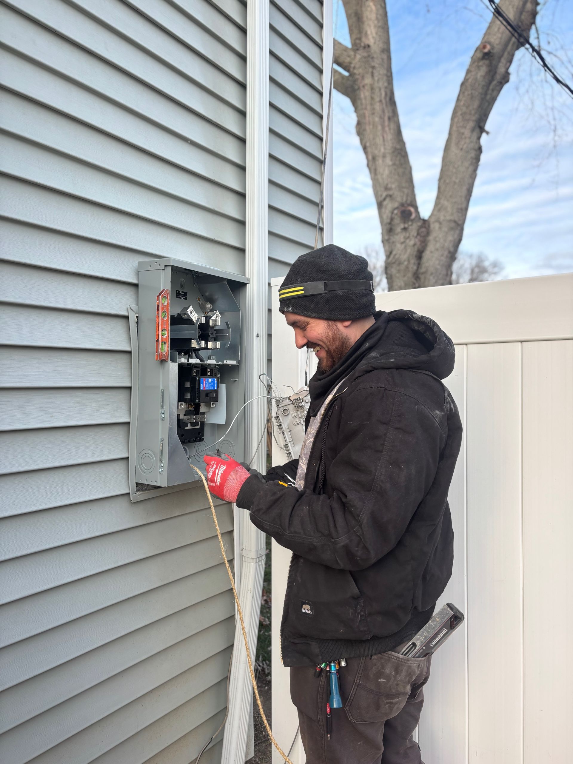 Bathroom under construction with a white vanity and shower area. Drywall and insulation are visible.