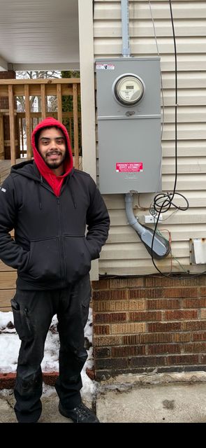 Burned electrical panel with charred wires and components.