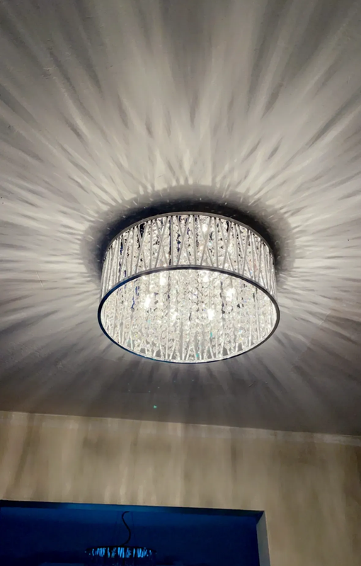 Two closed gray electrical panels mounted on a brick wall. Electrical wiring overhead.