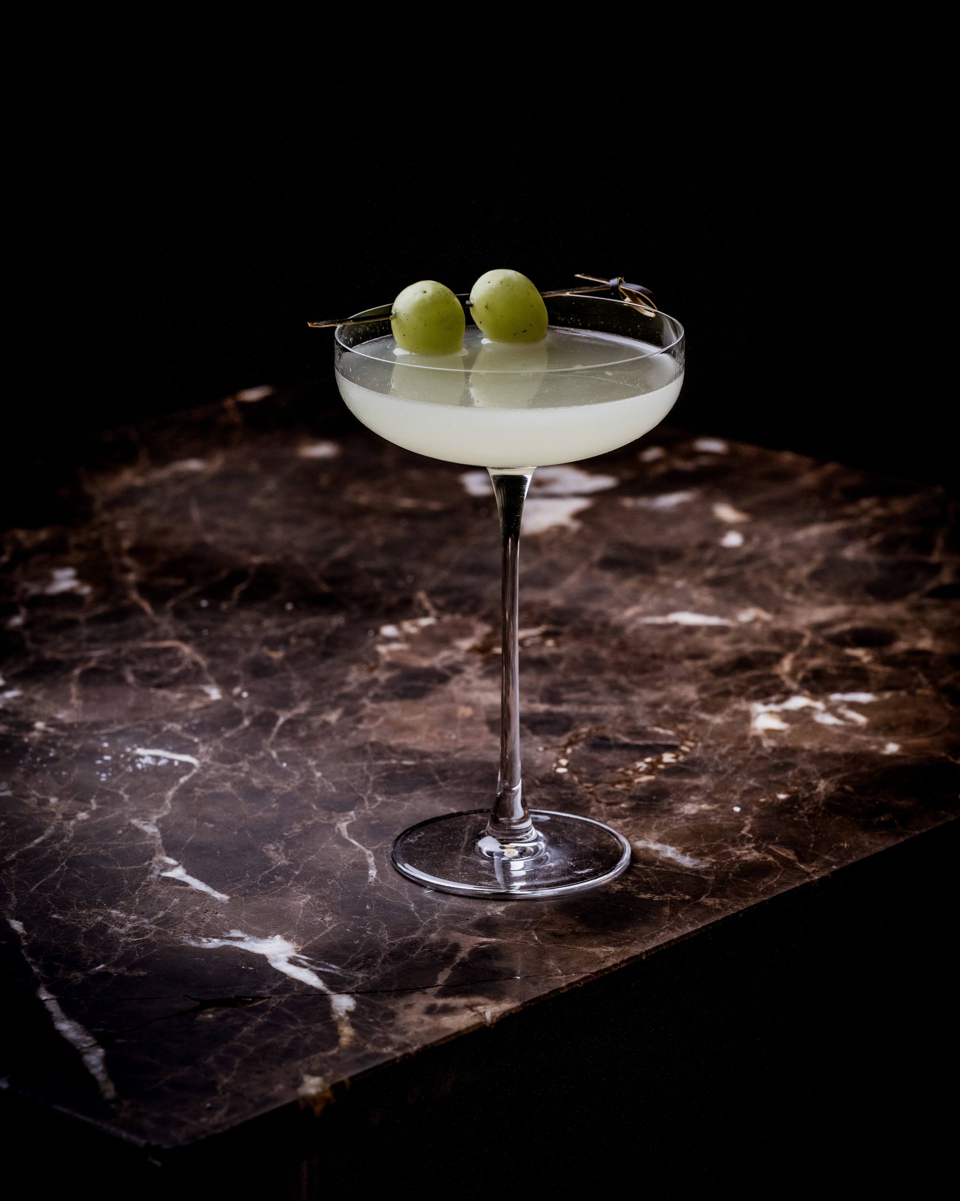Restaurant interior with diners at tables, server stands at center. Exposed brick, industrial ceiling.