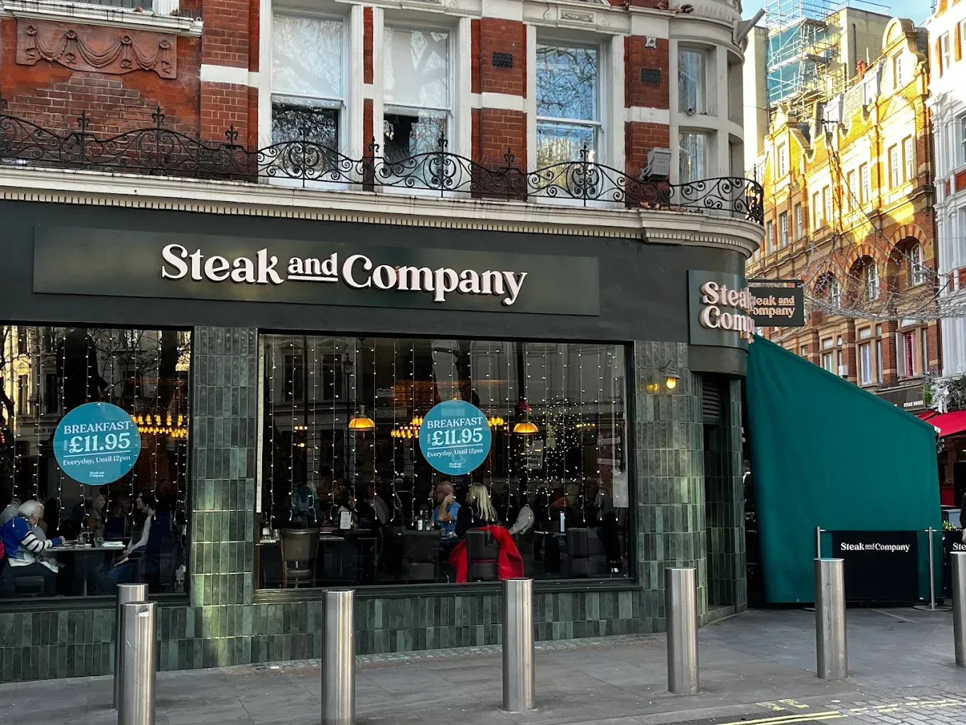 Steak and Company restaurant exterior with green tiles, windows, and sign in London.