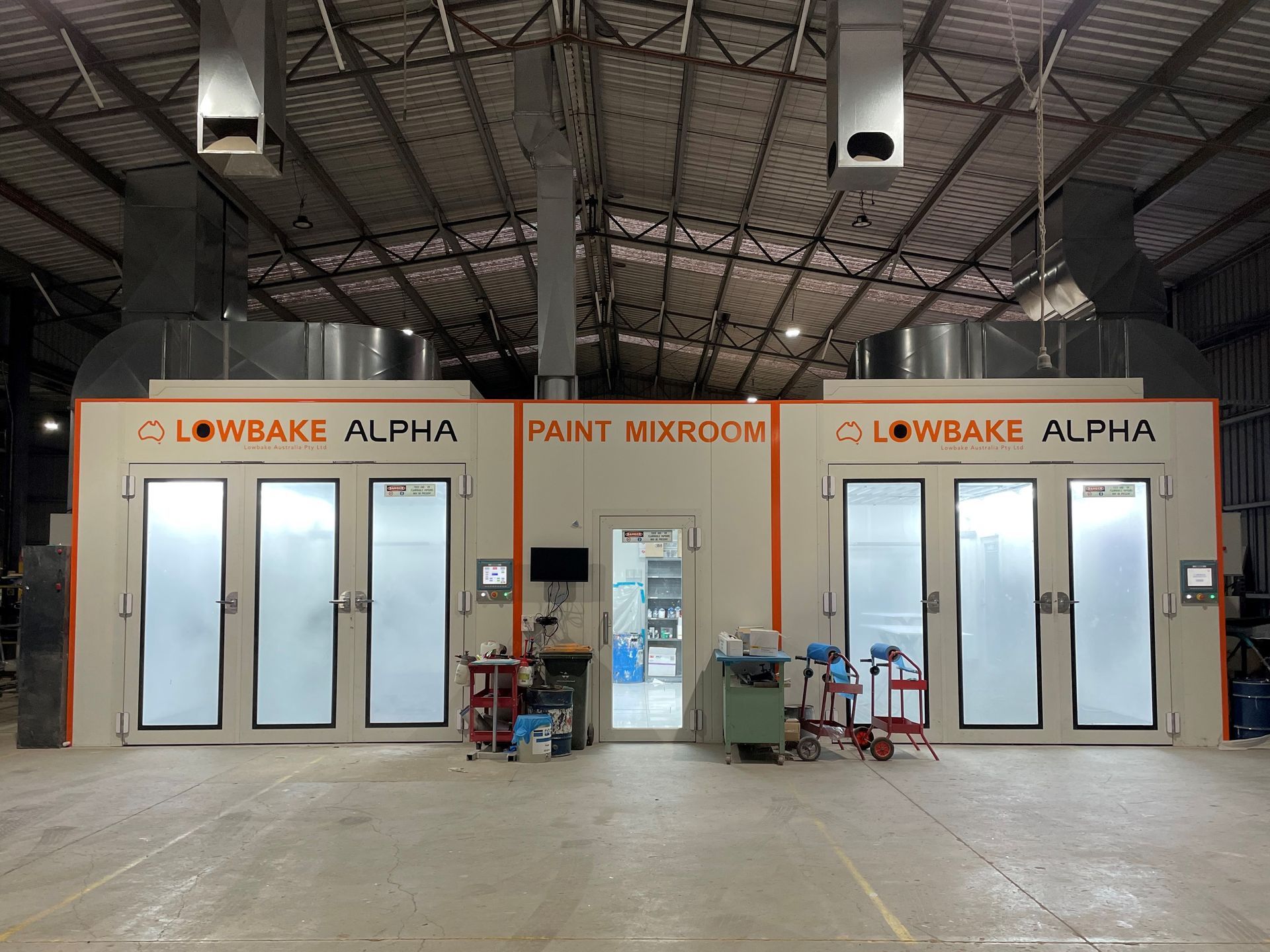 A large warehouse with a lot of doors and a ceiling.