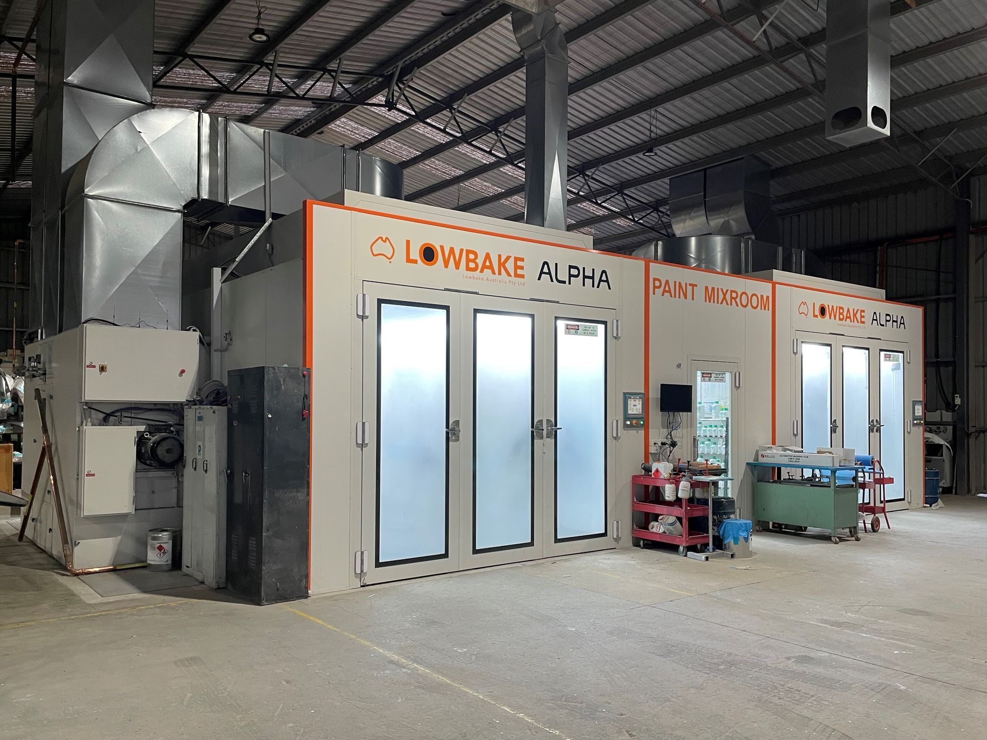 A large warehouse with a lot of doors and a lot of machinery.