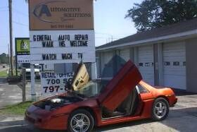 Vehicle with doors open and hood up during car tune up in Charleston, SC