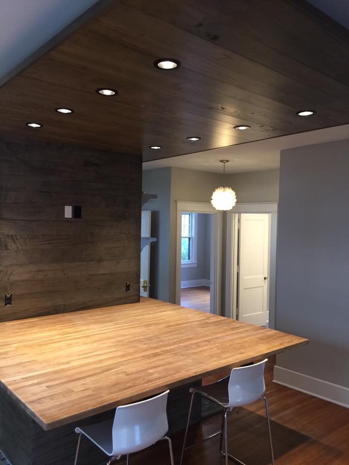 A kitchen with a wooden table and chairs