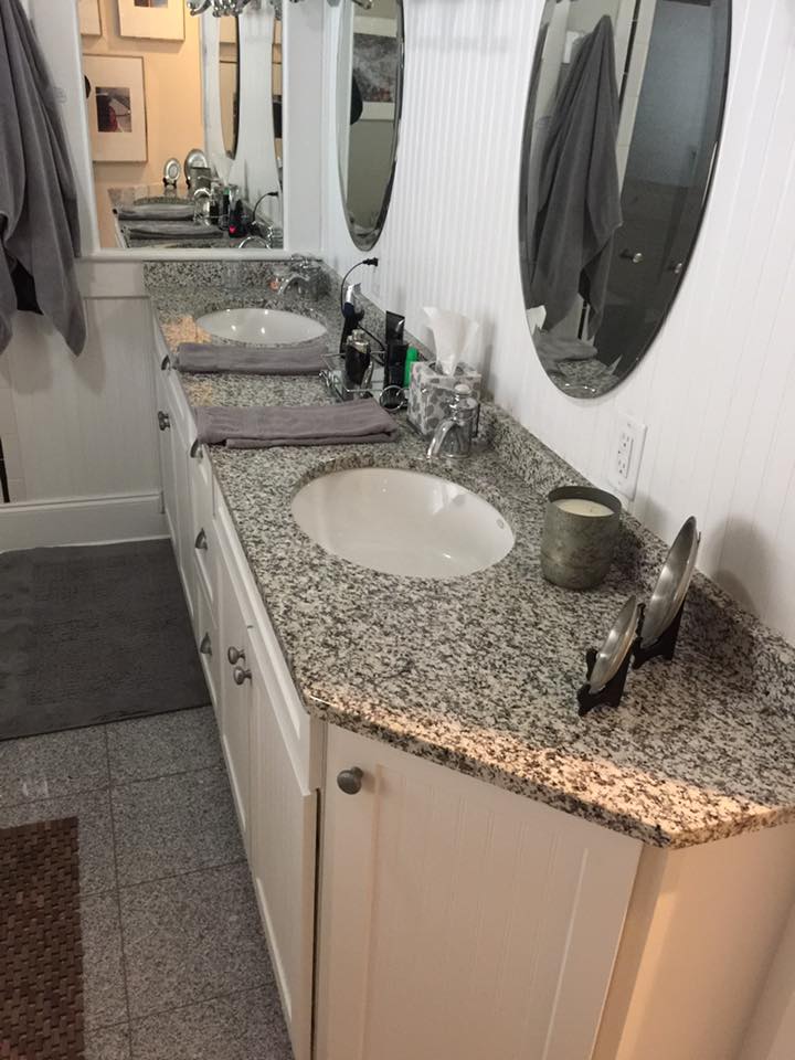 A bathroom with two sinks and two mirrors.