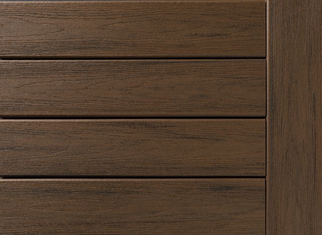 Brown wooden deck planks, horizontal, with a vertical border on the right.