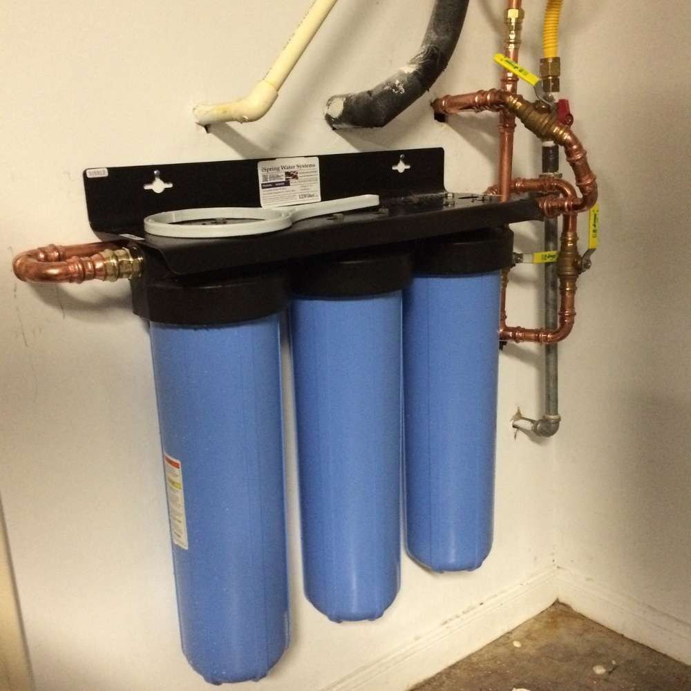 a water filter system is mounted to a wall