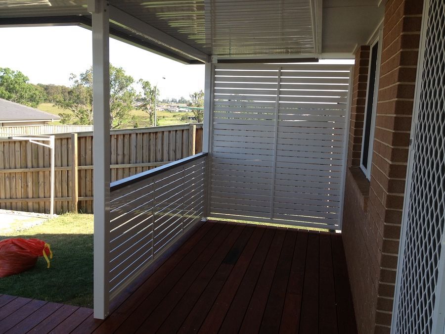 A White Privacy Screen on a Wooden Deck — Newcastle & MidCoast Privacy Screens & Gates In Mid North Coast, NSW