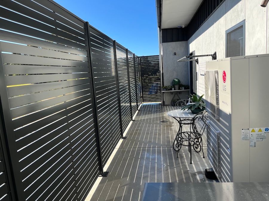 A Black Privacy Screen on the Side of a House — Newcastle & MidCoast Privacy Screens & Gates In Kurri Kurri, NSW