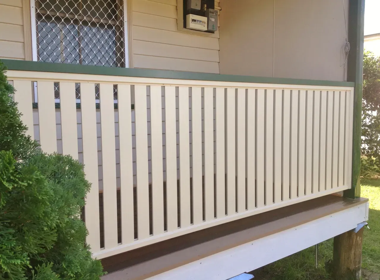 A White Fence Is Sitting On The Side Of A House — Newcastle & MidCoast Privacy Screens & Gates In Kurri Kurri, NSW