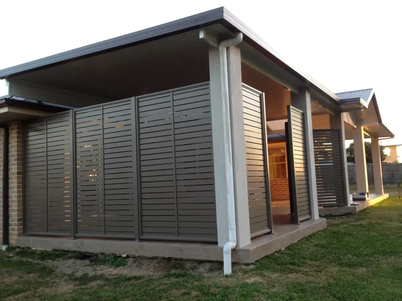 A House With a Lot of Shutters on the Side of It — Newcastle & MidCoast Privacy Screens & Gates In Newcastle, NSW