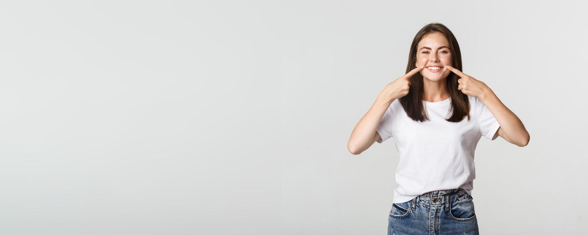 A young woman is making a funny face with her hands.