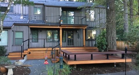 The back of a house with a large wooden deck.